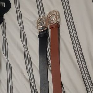 Tan and black belts. Gold buckle.